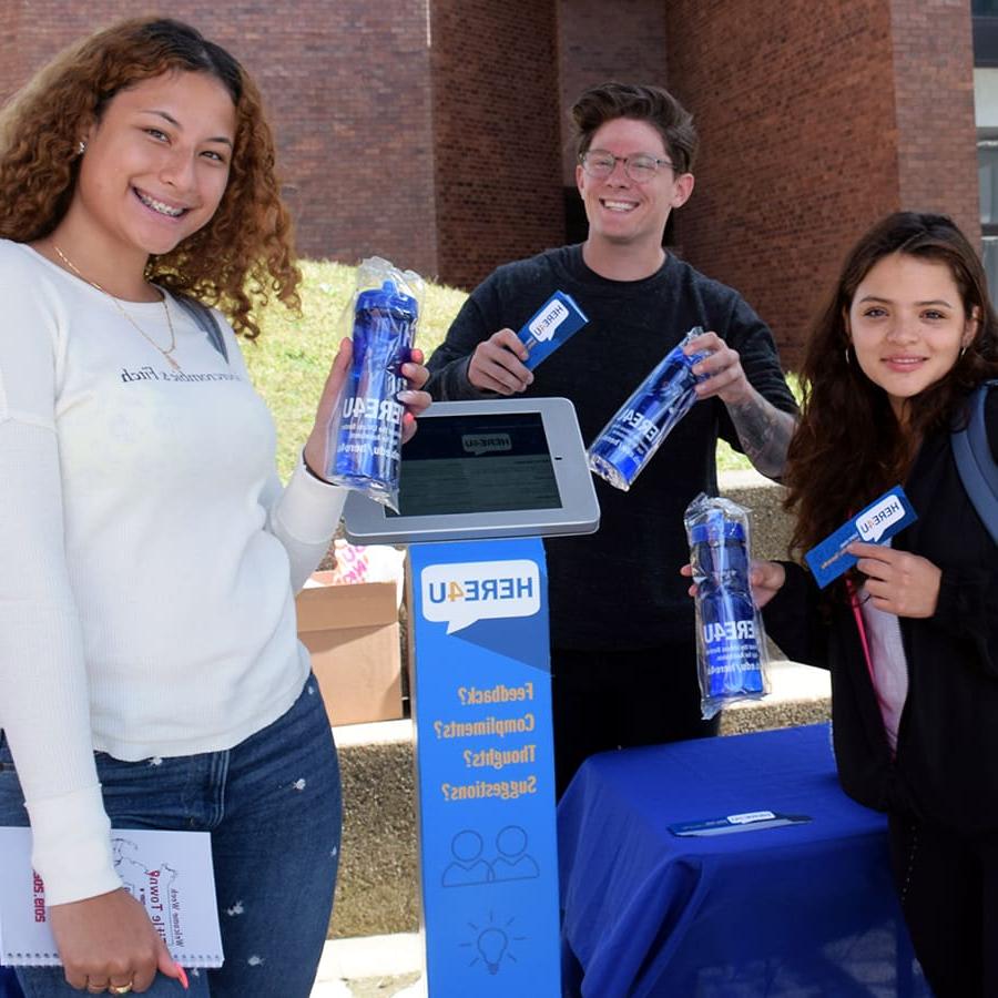 Students pose with here4u swag.